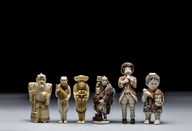 FOUR CARVED IVORY FIGURES AND TWO NETSUKE: FOUR CARVED IVORY FIGURES AND TWO NETSUKE The first carved ivory figure of an old man standing holding a broom with his right hand and a turtle in the other, the second carved ivory figure of a man st