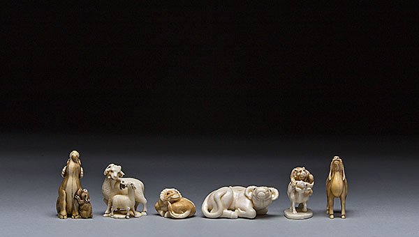 SIX CARVED IVORY NETSUKE OF HORNED ANIMALS: SIX CARVED IVORY NETSUKE The first netsuke of a sheep and a small lamb at its side, the second netsuke of a male goat sharing a tree branch with a baby goat, the third netsuke of a small sitting ram i