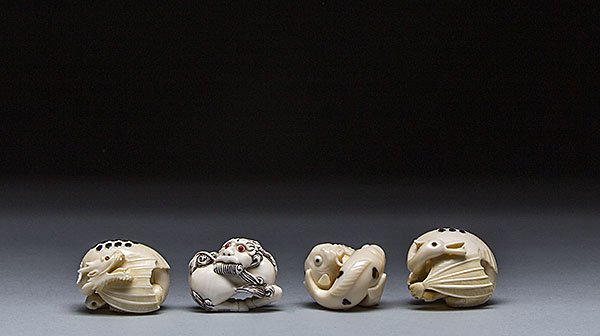 FOUR CARVED IVORY NETSUKE OF A DRAGON, SWAN, & CATFISH: FOUR CARVED IVORY NETSUKE OF A DRAGON, SWAN, & CATFISH The first netsuke of a dragon, the second netsuke of a Shi Shi, the third netsuke of catfish, the fourth netsuke of a dragon. All approximately 1
