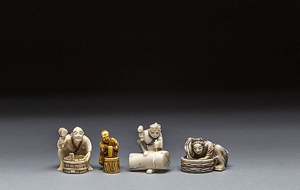 FOUR CARVED IVORY NETSUKE: FOUR CARVED IVORY NETSUKE The first netsuke of a man with hammer and a barrel, the second netsuke of a man standing with a barrel, the third netsuke of wood worker, the fourth netsuke of a lady washin