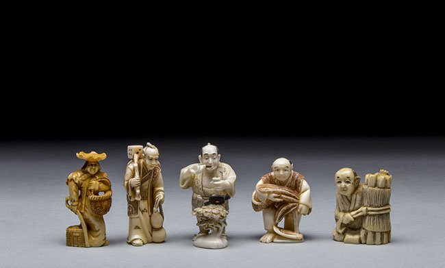 FIVE CARVED IVORY NETSUKE: FIVE CARVED IVORY NETSUKE. The first netsuke of a man standing with a basket, the second netsuke of the "vice man", the third netsuke of a man trimming his bonsai, the fourth netsuke of a man holding 