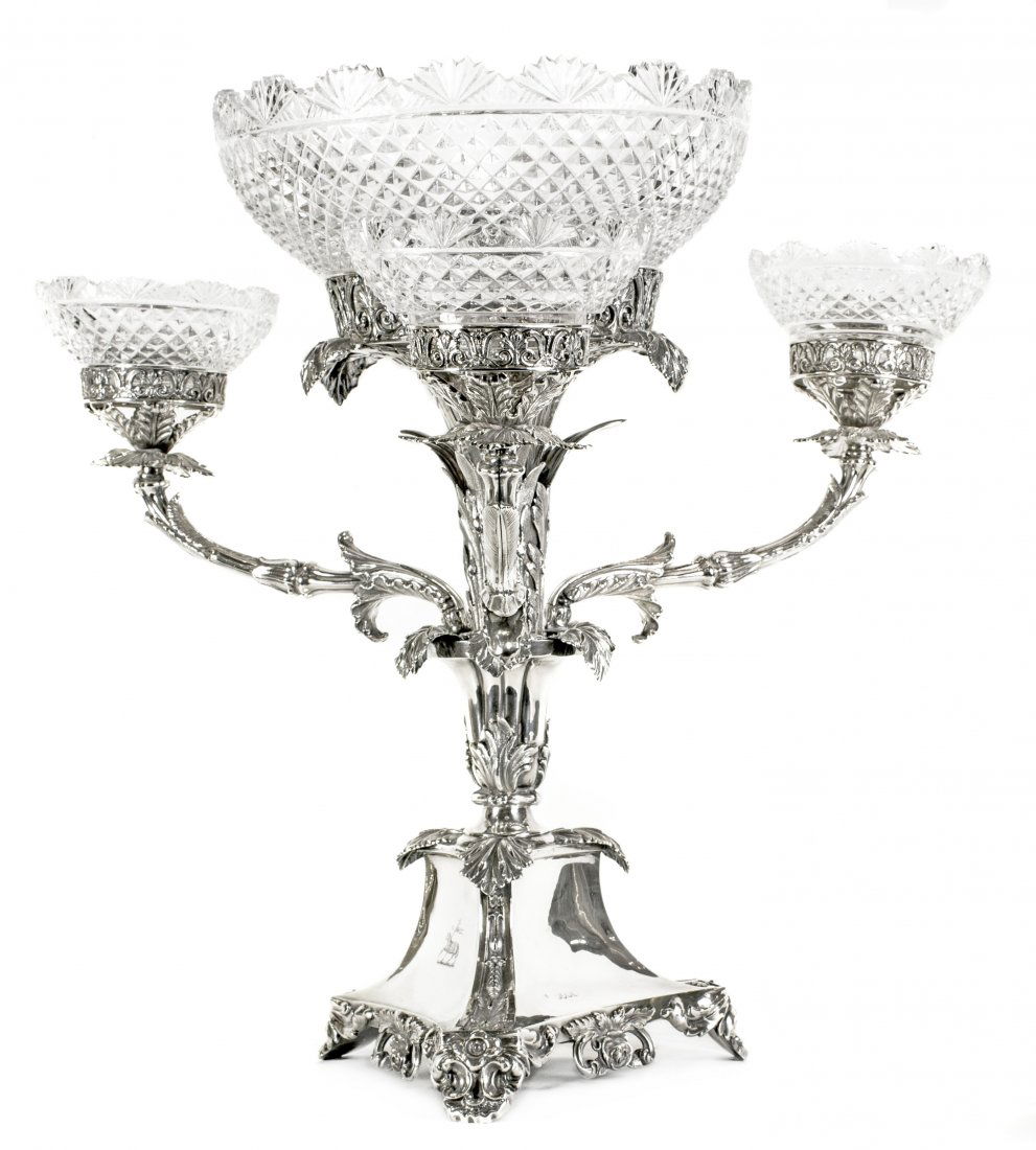 IMPRESSIVE ENGLISH SILVER & GLASS EPERGNE, LONDON 1850: IMPRESSIVE ENGLISH VICTORIAN SILVER AND CUT GLASS EPERGNE London, 1859-1860 makers mark: WS for Wm. Stevenson The triangular base supporting a leaf designed stem with three arms and a central cage,