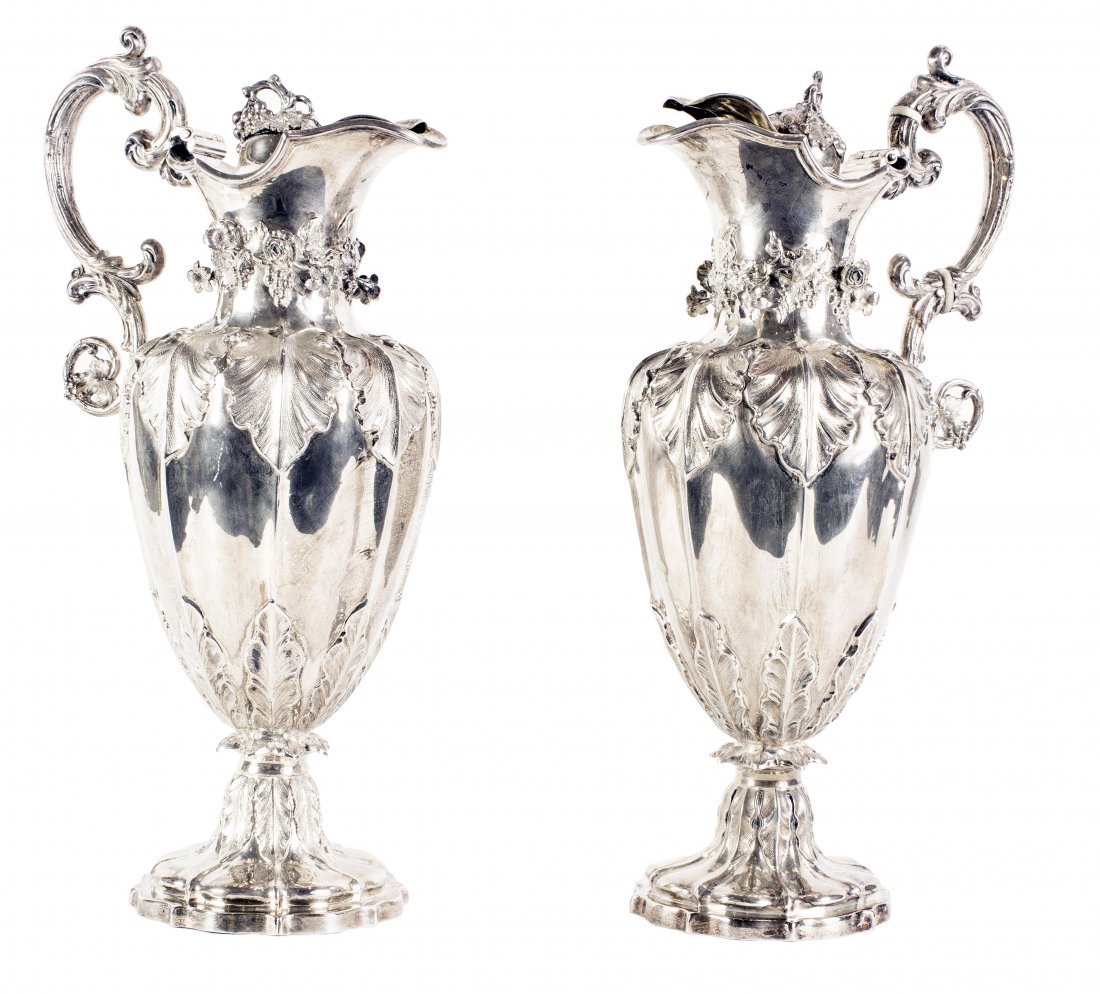 PAIR ENGLISH SILVER EWERS EARLY VICTORIAN: PAIR ENGLISH SILVER EWERS EARLY VICTORIANSheffield, 1838-39, & 1839-40 Makers mark H.W. & CO. for Hy Wilkinson & Co. Of baluster tapering form, cast with floral blossoms, and chased with leaves, the s