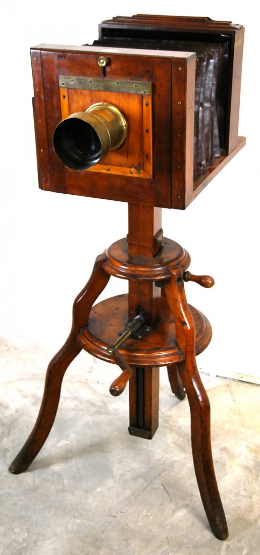 W. MORLEY TRIPOD STANDING MAHOGANY PLATE CAMERA, 1860: WILLIAM MORLEY STANDING TRIPOD MAHOGANY PLATE CAMERA, circa 1860, with manufacturers ivory tag, "W. Morley, 70 Upper Street London" Height: 51 in., Width: 27 in., Depth: 18 in. William Morley, conside