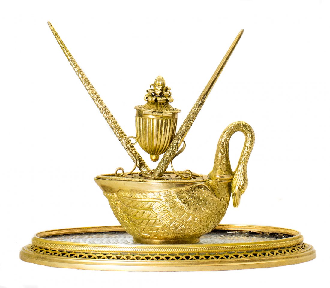 FINE ORMOLU INKWELL IN THE FORM OF A SWAN: FINE ORMOLU INKWELL IN THE FORM OF A SWAN On a mirrored oval base in a gilded frame. Height 5 in., Length 9 in. Height 12.7 cm, Length 22.8 cm