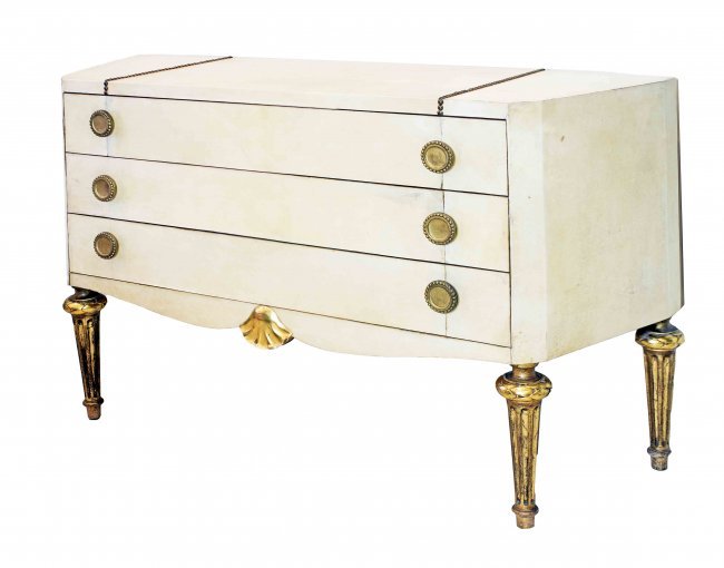 FRENCH GILT-WOOD PARCHMENT COMMODE ATTRIBUTED JANSEN: FRENCH PARCEL GILT-WOOD AND TACK MOUNTED PARCHMENT COMMODECirca 1940 Attributed to Maison Jansen, Paris, of shaped rectangular form with canted sides, the top with two rows of decorative tacks, with t