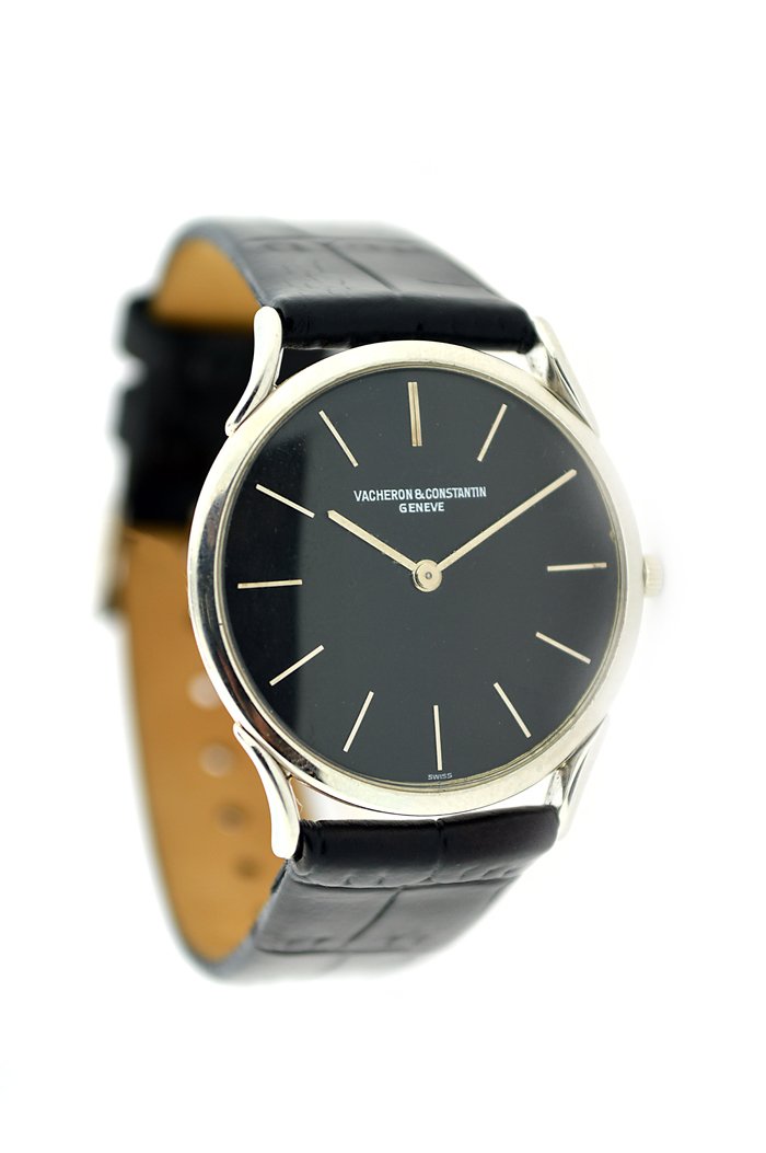 PLATINUM VACHERON CONSTANTIN ULTRA THIN WRISTWATCH: PLATINUM VACHERON CONSTANTIN ULTRA THIN WRISTWATCH Swiss, manual wind, the round black dial with applied markers, on a black leather strap with a Vacheron Constantin, with an 18 karat white gold Malte
