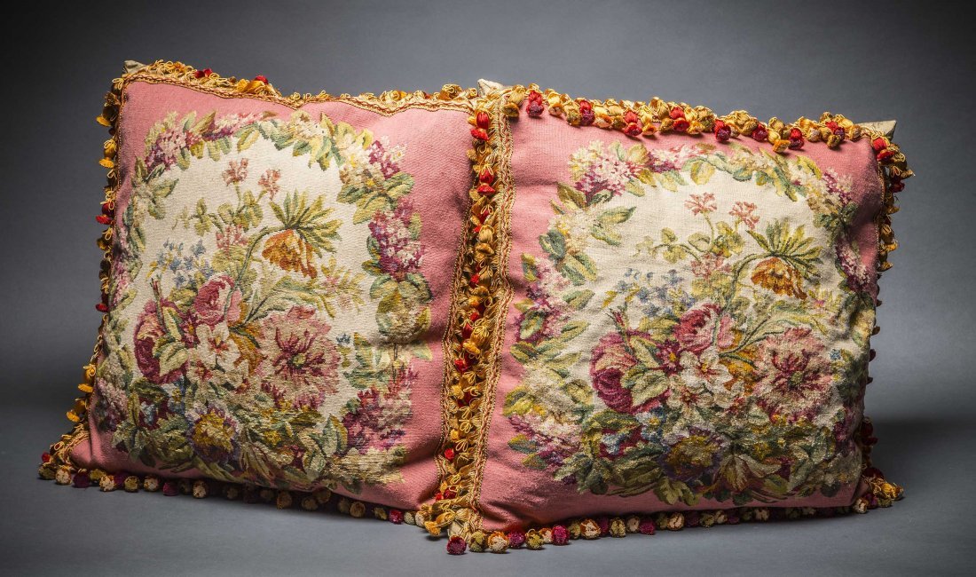 PAIR OF AUBUSSON FLORAL BOUQUET PANELS, PILLOWS: PAIR OF AUBUSSON FLORAL BOUQUET PANELS, NOW FITTED AS PILLOWS The Panels 19th Century, the large pillows with a pink silk backing and cord border, with tassels. 25 by 25 in. 63.5 by 63.5 cm