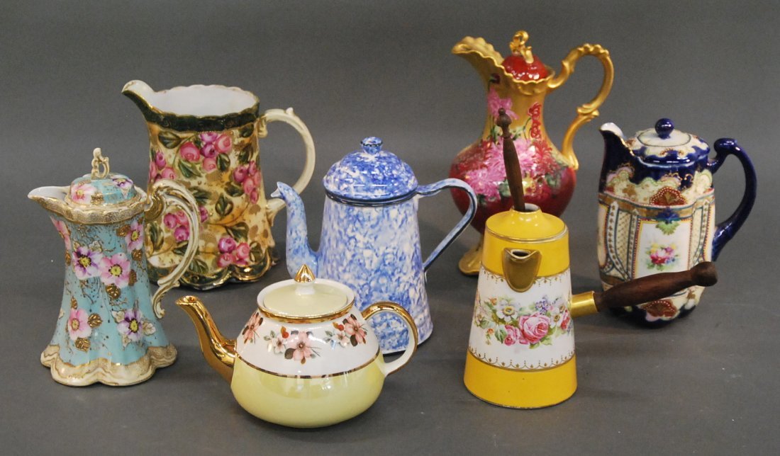6 PORCELAIN TEAPOTS, COFFEE POTS & A PITCHER, 19TH/20TH: SIX VARIOUSLY ENAMELED PORCELAIN TEA AND COFFEE POTS AND A PITCHER 19th/20th century, most marked, comprising a Nippon pitcher and two Nippon coffee pots, an English Gibson's Staffordshire floral deco