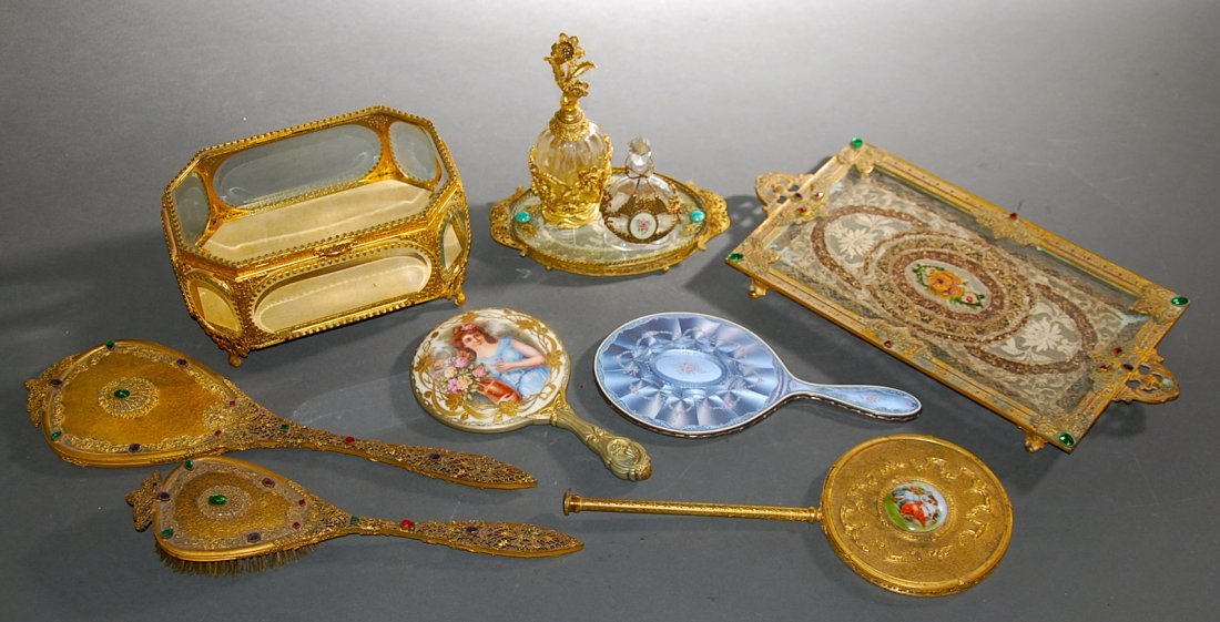 9 GILT METAL & BRONZE DRESSING ITEMS & SILVER MIRROR: LARGE GROUP OF NINE LADIE'S GILT METAL AND BRONZE DRESSING TABLE ITEMS AND A SWISS SILVER AND BLUE ENAMEL HAND HELD MIRROR Late 19th/early 20th century, mostly French, comprising a rectangular gilt me
