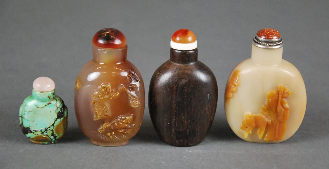 FOUR CHINESE CARVED JADE & TURQUOISE SNUFF BOTTLES: FOUR ASSORTED CHINESE CARVED SNUFF BOTTLES Comprising a jade example of ovoid form with rounded shoulders carved to the front with the god of longevity, a carnelian colored agate example, of ovoid for