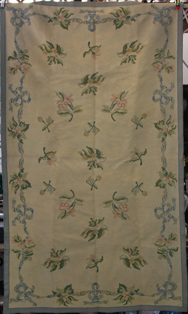 PORTUGUESE NEEDLEPOINT RUGS, CIRCA 1950: PORTUGUESE NEEDLEPOINT RUGS, circa 1950 each with entwined fruited and floral garlands on a cream ground. with manufactures lablel on the reverse of one. 8 ft by 4ft. 9 in.