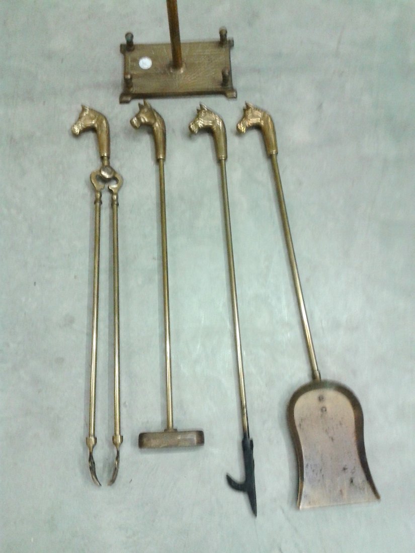 EQUESTRIAN BRASS FIREPLACE TOOLS AND STAND, 1900: SET OF ENGLISH BRASS EQUESTRIAN FIREPLACE TOOLS AND STOOD Late 19th /early 20th century, comprising a shovel, a brush, (lacks bristles), a poker and tongs each with a horse head Height 32 in.
