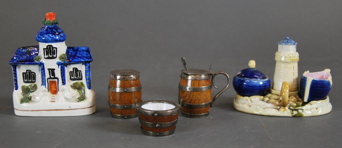 VARIED SALT CELLARS AND A STAFFORDSHIRE COTTAGE: THREE ENGLISH SILVER PLATE MOUNTED OAK AND OPALINE BARREL FORM SALTS,A NAUTICAL THEMED CONDIMENT SET AND A STAFFORDSHIRE EARTHENWARE COTTAGE, late 19th/early 20th century. Condiment Set Height: 6in.