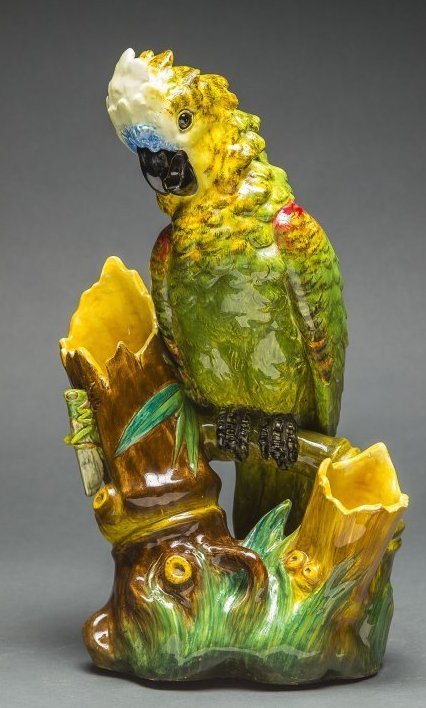 FRENCH DELPHIN MASSIER MAJOLICA MODEL OF A COCKATOO,: FINE FRENCH DELPHIN MASSIER MAJOLICA MODEL OF A COCKATOO circa 1885, Delphin Massier, well modeled and brightly painted, the bird rests between two bamboo stumps, the underside inscribed in black Delp