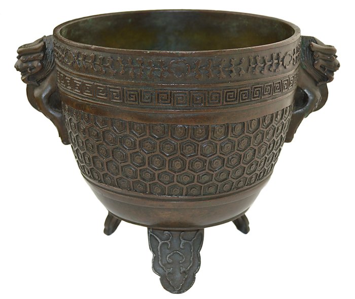 BRONZE TRIPOD CENSOR QIANLONG SIX-CHARACTER SEAL MARKS: A BRONZE TRIPOD CENSOR CHINESE,QIANLONG SIX-CHARACTER SEAL MARKS AND OF THE PERIOD(1736-95) The vessel has a round body raised on short legs , and a pair of dragon handles on opposite sides. The exter