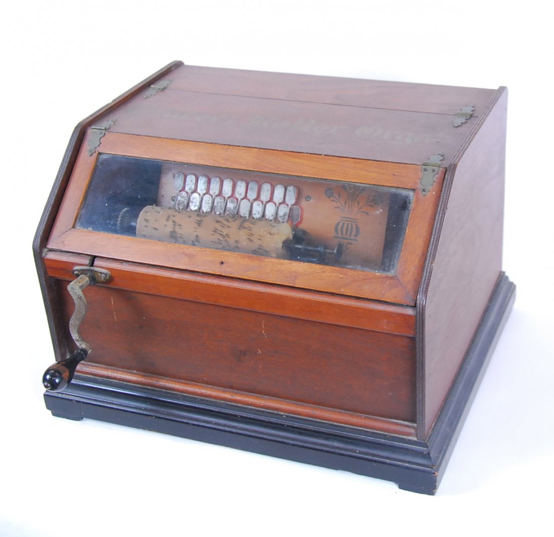 SWISS CONCERT "ROLLER ORGAN" WOOD CYLINDER MUSIC BOX: SWISS "CONCERT ROLLER ORGAN" WOOD CYLINDER MUSIC BOX Circa 1900, with the title "Concert Roller Organ" stencilled upon the rectangular part-ebonized walnut case, the hinged slant front with glazed pan