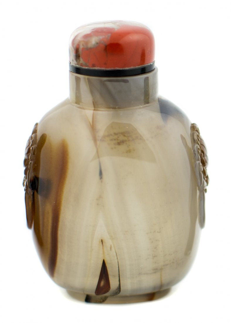 FINE CARNELIAN AGATE SNUFF BOTTLE CHINESE 19TH CENTURY: A FINE CARNELIAN AGATE SNUFF BOTTLE CHINESE 19TH CENTURY Of ovoid shape with rounded shoulders carved with lion-mask ring handles, well hollowed. stopper 2.75 in. (7.10 cm.)
