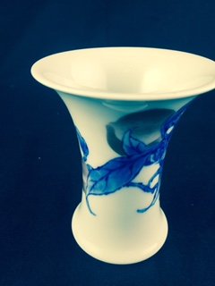 PORCELAIN VASE BY MAKUZU KOZAN II, JAPANESE (1859-1940): A studio ware porcelain vaseBy Makuzu Kozan II (Miyagawa Hanzan, 1859-1940)Of beaker form with a wide trumpet mouth and finely painted in underglaze red and blue with a leafy spray of fruiting peaches
