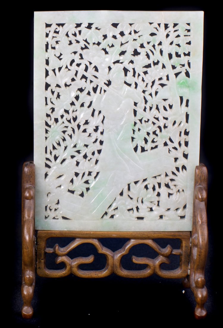 LAVENDER JADE TABLE SCREEN, CHINESE: A PALE LAVENDER JADE TABLE SCREEN CHINESE 20TH CENTURY Carved and pierced with a quan yin surrounded by flowers , the softly polished stone is of a pale lavender-white color. 8.5 in. (21.25 cm.) high 