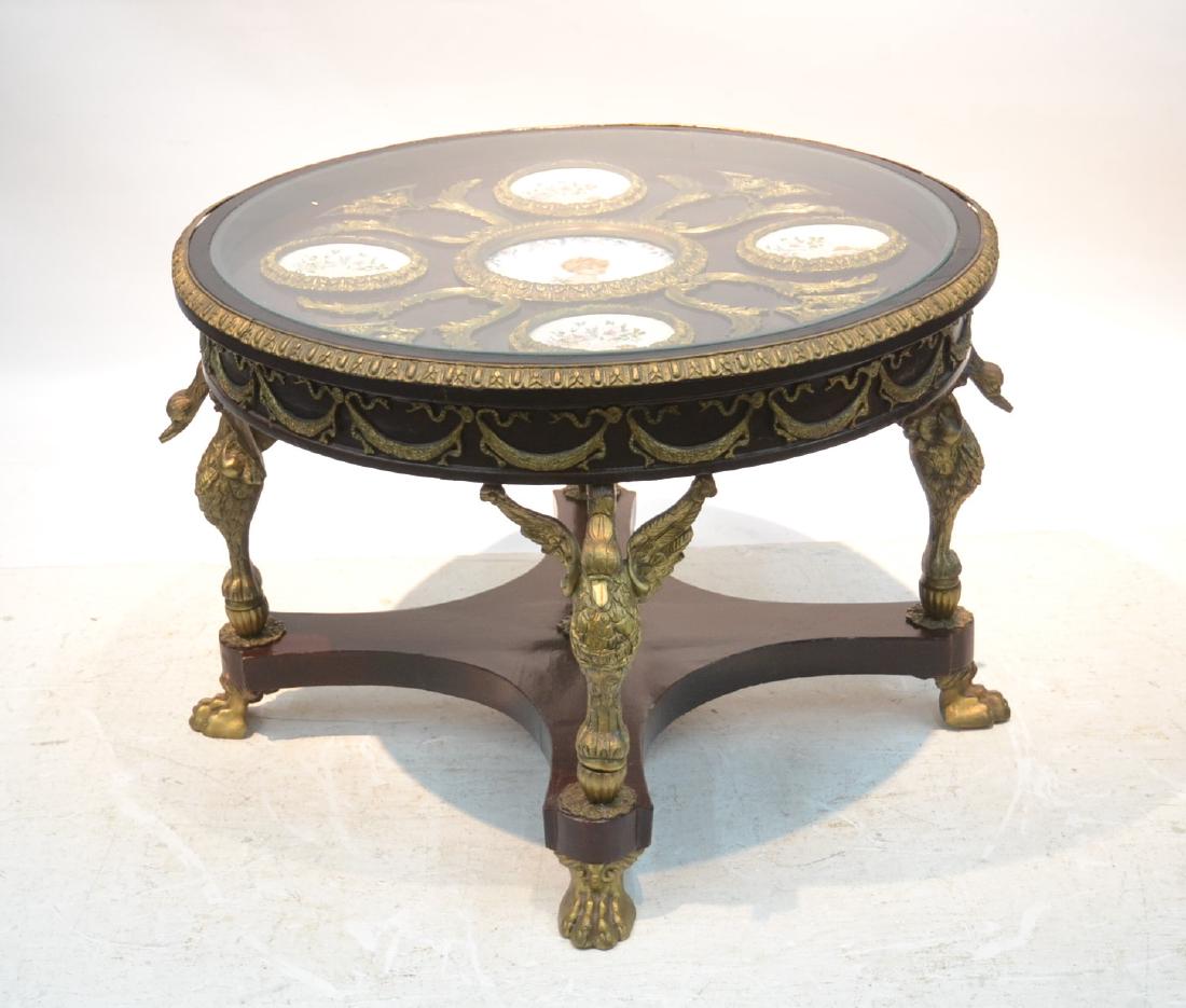 LARGE CHERRY WOOD & BRONZE TEA TABLE: WITH BRONZE MOUNTS & (4) WINGED BIRDS & CLAW FEET SUPPORTING GLASS TOP WITH (5) PORCELAIN PORTRAIT PLATES - 35" x 24"