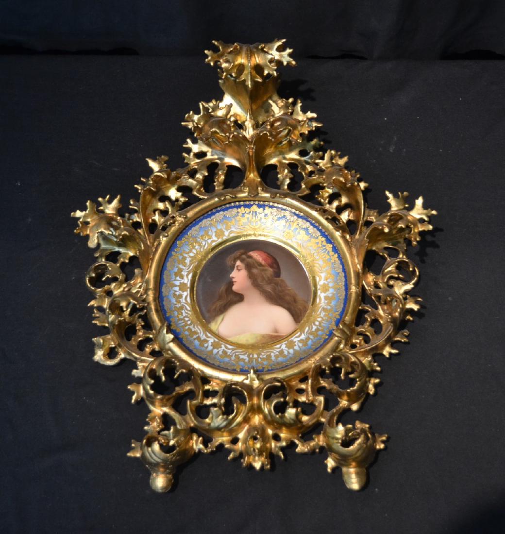 HAND PAINTED ROYAL VIENNA PORTRAIT PLATE OF: WOMAN WITH FLOWING HAIR ; SURROUNDED BY HEAVY RAISED GOLD & SILVER FOLIATE DESIGNS ; ARTIST SIGNED WAGNER , SET IN LARGE 19thC CARVED ITALIAN FRAME ; PLATE MARKED UNA GITANOI , DEPOSE - PLATE IS 10" ;
