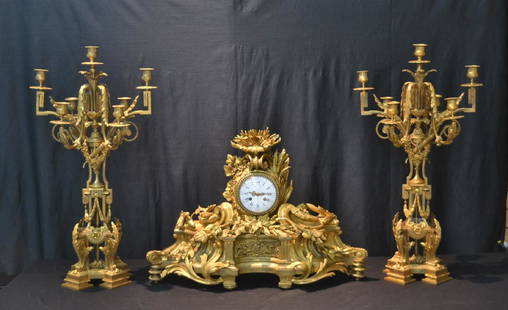 LARGE 19thC FRENCH RAINGO FRERES BRONZE CLOCK: WITH FOLIATE , GRAPES , SCROLLWORK & (3) PUTTIS PLAYING & (Pr) LARGE BRONZE CANDELABRAS (16" X 32") & CLOCK IS 29" x 11" x 21"