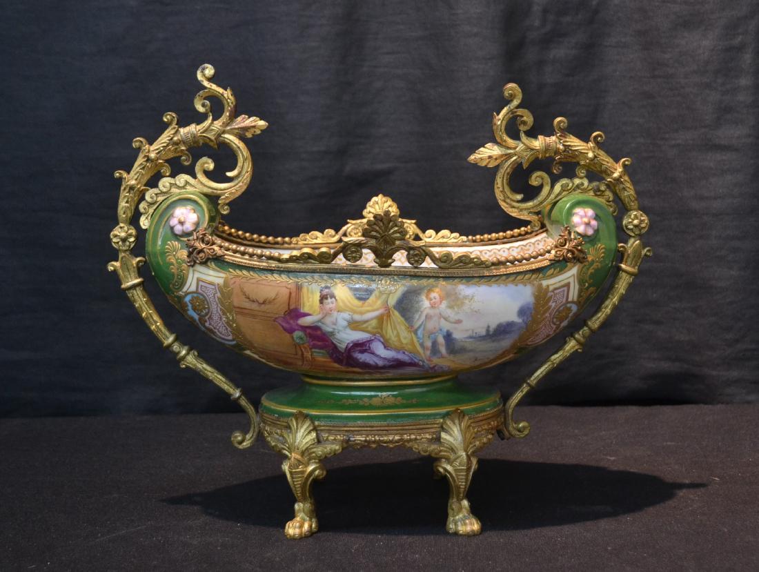 ASYMETRICAL HAND PAINTED SEVRES & BRONZE: CENTERPIECE BOWL WITH SCENE DEPICTING RECLINING WOMAN WITH PUTTI ON RECAMIER ; ARTIST SIGNED - 13" x 6" x 11"