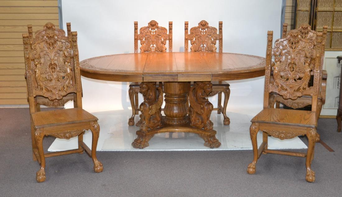 HEAVILY CARVED OAK ROUND DINING ROOM TABLE: & (6) CARVED CHAIRS INCLUDING (Pr) ARM CHAIRS WITH CARVED GARGOYLES , LION HEADS , BALL & CLAW FEET - TABLES IS 30" x 55" WITH (2) 11 1/2" LEAVES ;CHAIRS ARE 21 1/2" x 18" x 45"
