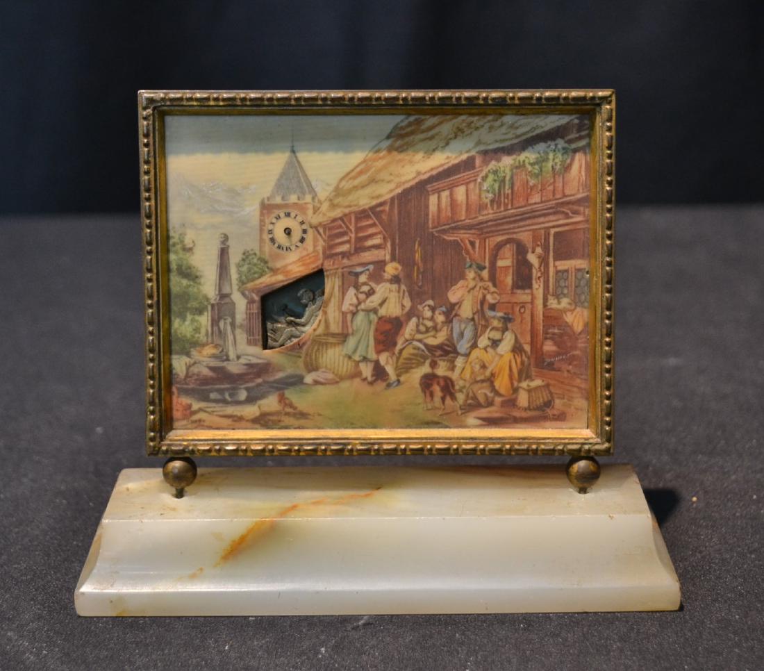 SWISS BRONZE & CELLULOID ON ONYX MINIATURE CLOCK: WITH VILLAGE SCENE & AUTOMATON MAN WITH ANVIL MOVING UP & DOWN ; MARKED TDYLLE AU VILLAGE , FAB JAISSE (MISSING HANDS) CLOCK PORTION IS 4 1/4" x 3" ; OVERALL IS 5" x 1 1/2" x 4 1/2"