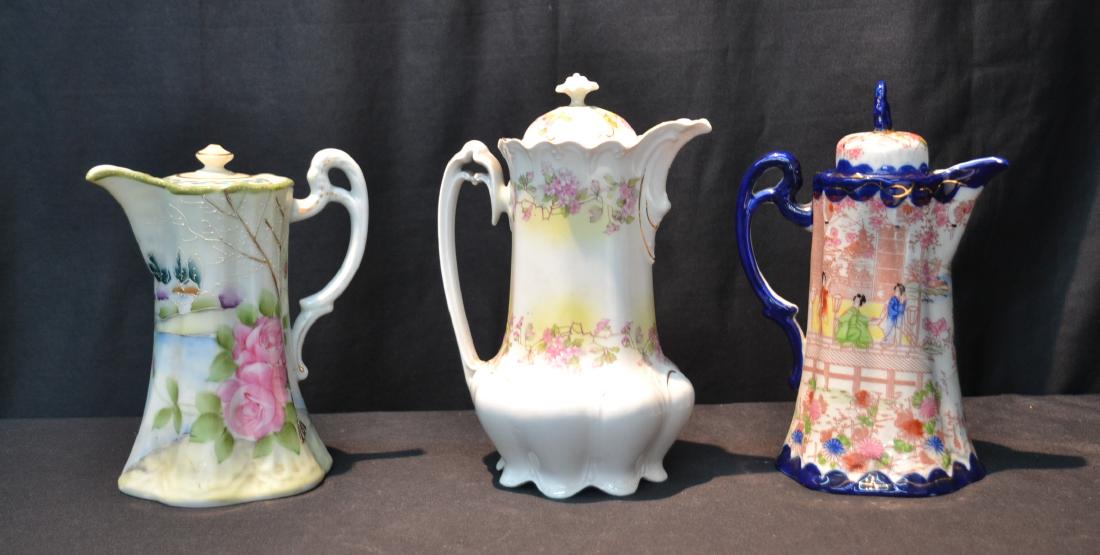 (3) PORCELAIN CHOCOLATE POTS TO INCLUDE: (2) NIPPON & (1) AUSTRIAN (ONE HAS CHIP, ONE MISSING COVER & ONE HAS GLUED FINIAL) LARGEST IS 6 1/2" x 9 1/2"