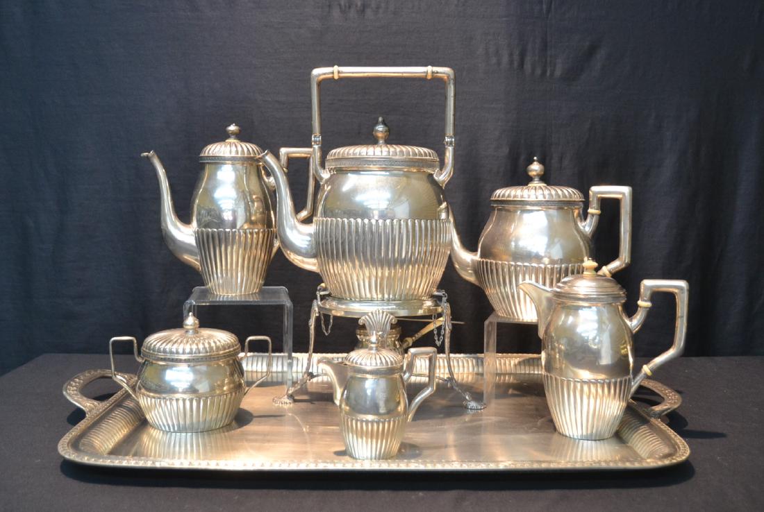 (7)pc AUSTRIAN SILVER TEA SET WITH LARGE SILVER: TRAY , HAVING ENGRAVED CREST ; CONSISTING OF SWING POT , COFFEE POT, TEA POT , SUGAR , CREAMER (ONE HAS REPLACED LID) HALLMARKED HV ; WITH ES OR SE MONOGRAM - 244ozt GROSS ; TRAY IS 24" x 18 1/2" & SW