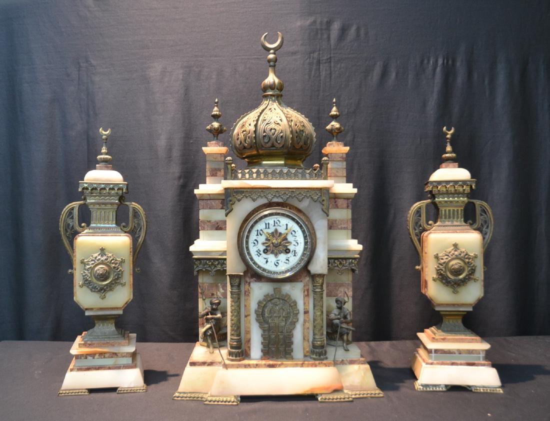 (3)pc FRENCH ORIENTALIST MARBLE & BRONZE CLOCK SET: WITH MOSQUE FORM CLOCK WITH ARAB SEATED FIGURES ALONG COLUMNS WITH DOOR & MATCHING MARBLE GARNITURE WITH BRONZE MOUNTS - CLOCK IS 14" x 6 1/2" x 27" , GARNITURE IS 6" x 5" x 19"