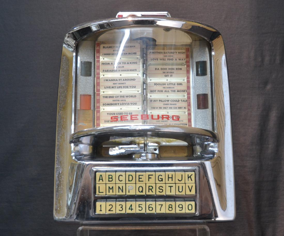SEEBURG TABLE TOP COIN OPERATED JUKE BOX: DINER TABLE TOP COIN OPERATED TABLE TOP JUKE BOX ; SEEBURG WALL-O-MATIC , 1966 - 12 1/2" x 7 1/2" x 14 1/2"