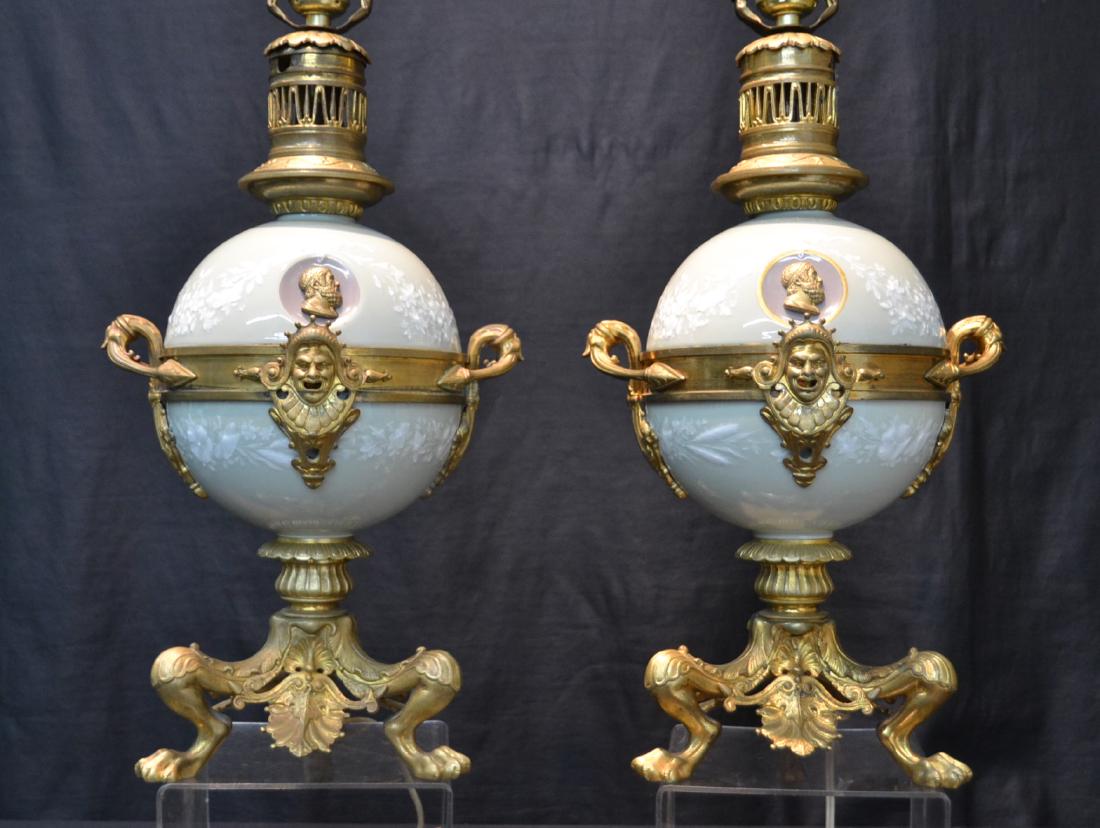 (Pr)19thC PATE SUR PATE PORCELAIN & BRONZE LAMPS: (Pr) FINE PATE SUR PATE PORCELAIN GLOBULAR FORM ELECTRIFIED OIL LAMPS WITH ROMAN INSET BRONZE PORTRAITS RAISED ON BRONZE TRIPOD CLAW FOOT BASE ; HAVING BRONZE MASKS - 9 1/2" x 7 1/2" x 19" TO SOCKET