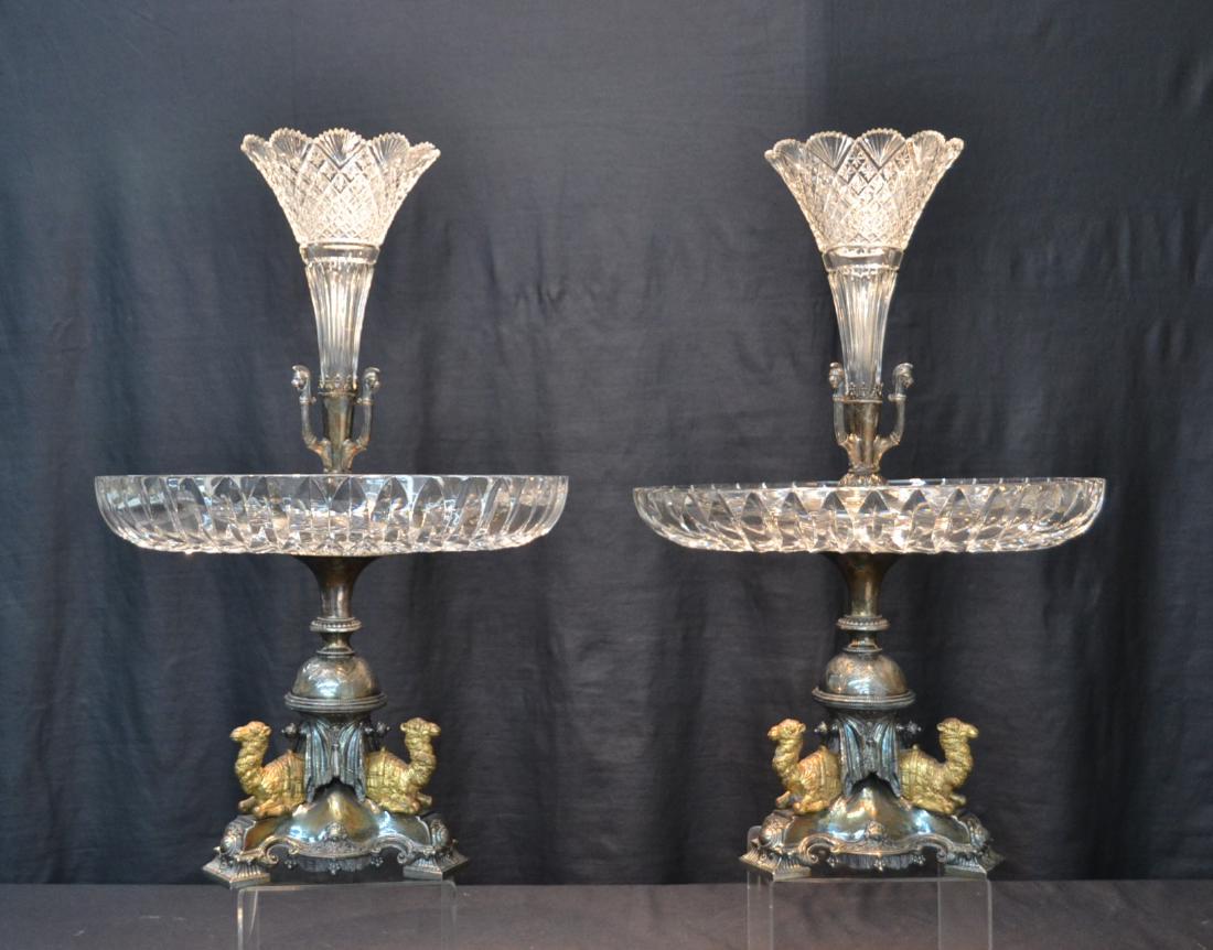 (Pr) ENGLISH VICTORIAN SILVER PLATE CENTER PIECES: WITH CAMELS KNEELING ON TRIPOD BASE , WITH CUT GLASS TAZZA & EPERGNE WITH ROMAN HEADS - 13 1/2" x 21" ; HAS ENGLISH HALLMARKS ; ATTRIBUTED TO WALKER & HALL - 13 1/2" x 21" OVERALL