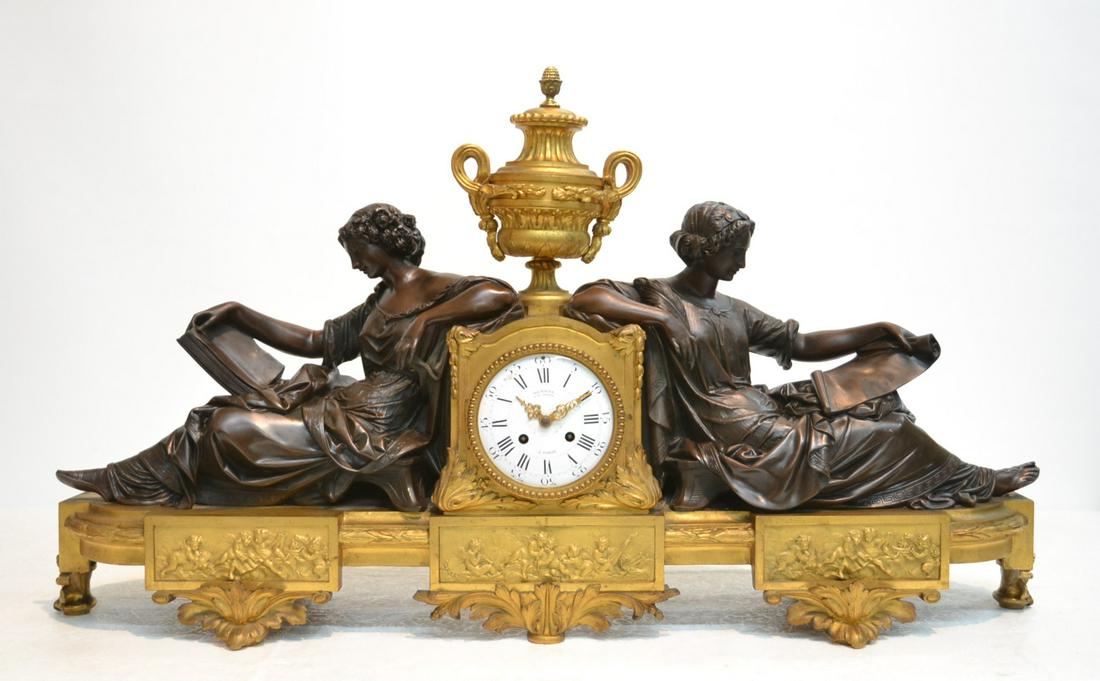 LARGE 2-TONE FRENCH BRONZE CLOCK: WITH (2) RECLINING PATINATED WOMEN READING BOOKS ASIDE CLOCK WITH GILDED BRONZE BASE & URN FORM TOP ; CLOCK FACE IS MARKED DENIERE et de BRONZES , A PARIS ; WITH MEDAILLE D'OR MOVEMENT - 33 1/2" x 6" 