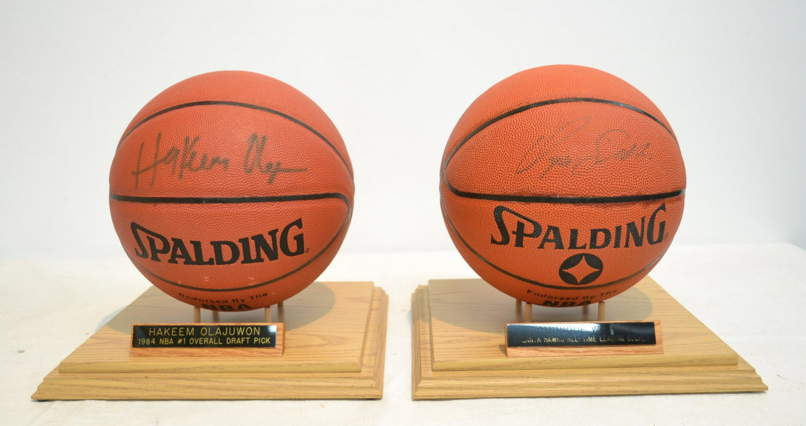 HAKEEM OLAJUWON & DOMINIQUE WILKINS: AUTOGRAPHED BASKETBALLS IN SHADOW BOX DISPLAY CASE WITH SCOREBAORD CERTIFICATE