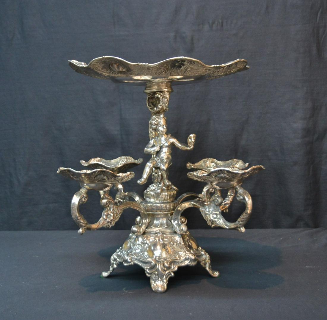 LARGE STERLING SILVER CENTERPIECE EPERGNE: LARGE STERLING SILVER CENTERPIECE WITH PUTTI AT CENTER HOLDING TOP TIER TAZZA WITH 4-ARMS BELOW , MARKED RC 925 - 17 1/2" x 16" ; 116ozt