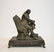 WHITE METAL SCULPTURE OF SEATED BEN FRANKLIN