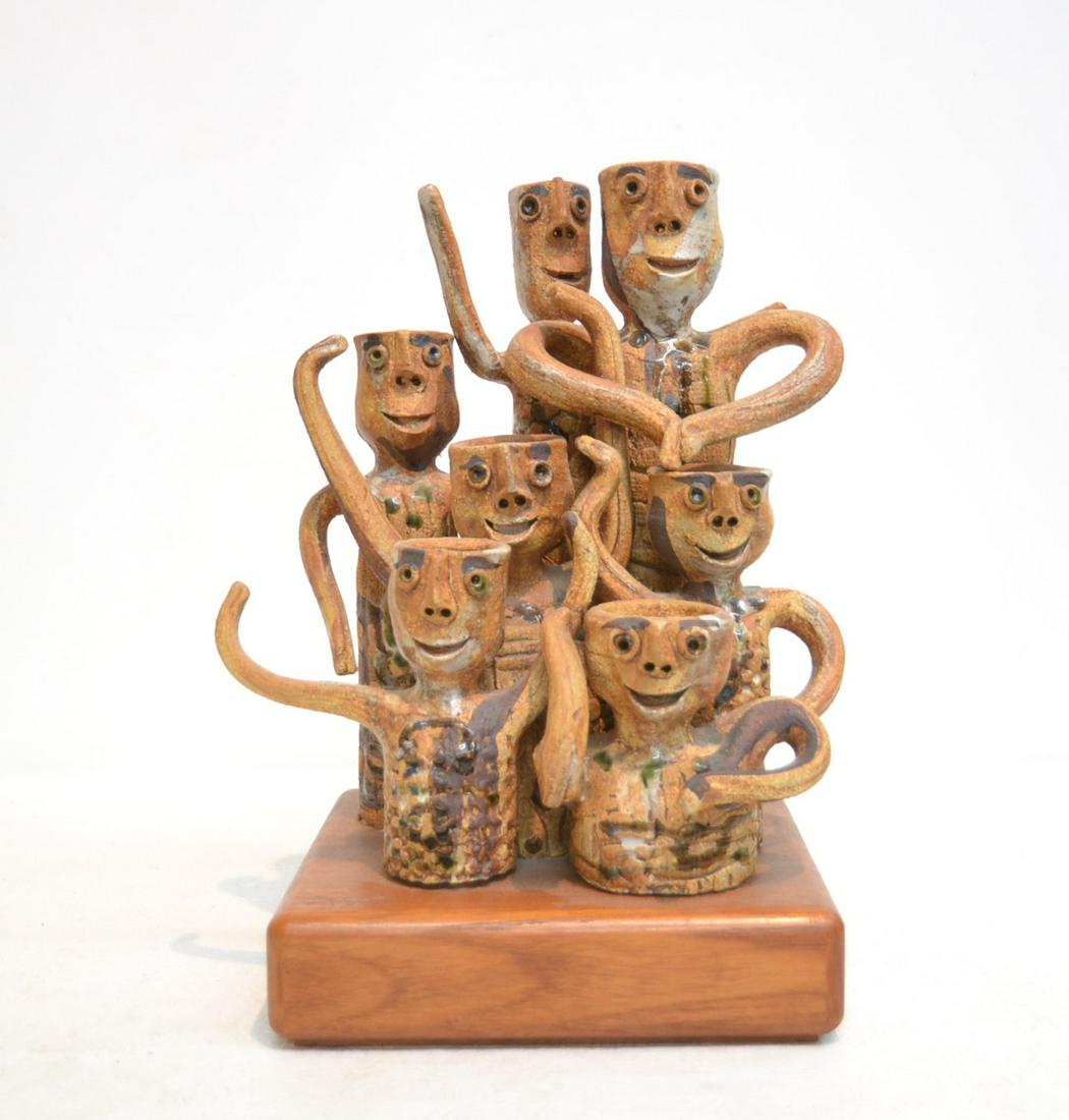 HAL FROMHOLD (20thC , LOS ANGELES): CERAMIC GROUPING OF (7) FIGURES , ON TEAK BASE , SIGNED ON BACK (SMALL FIGURE IN FRONT HAS ARM REPAIR) 9 1/2" x 8" x 13"