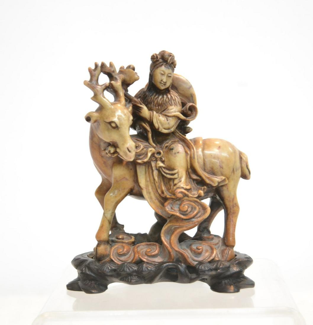 CARVED SOAPSTONE FIGURE RIDING GOAT: ON WOOD BASE - 4 1/2" x 2 1/2" x 5 1/2"