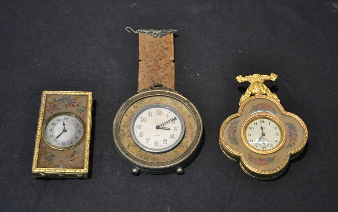 (3) ANTIQUE TRAVEL CLOCKS INCLUDING: ANGELUS 8-DAY SWISS CLOCK & (2) AUSTRIAN TRAVEL CLOCKS WITH EMBRODIERY - LARGEST IS 4" x 5"
