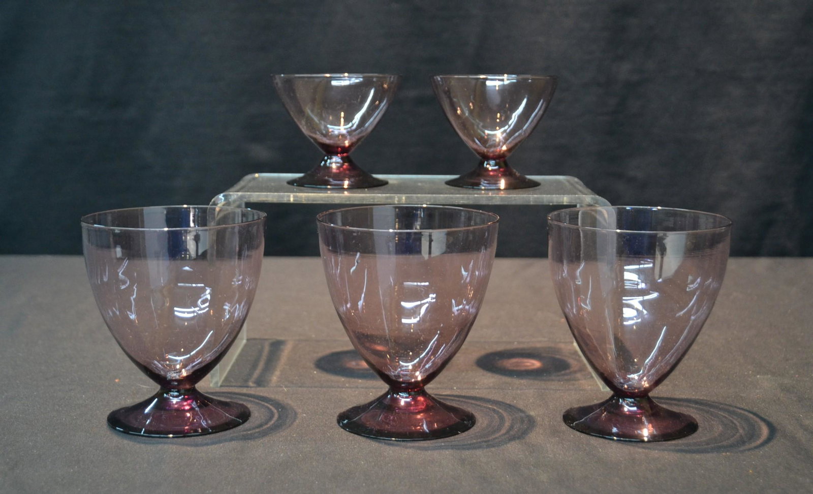(5) AMETHYST STEUBEN GLASS GOBLET GLASSES: (Pr) SMALL STEUBEN GOBLETS WITH STEUBEN ACID MARK & ONE OF THE LARGER GLASSES HAS THE STEUBEN ACID MARK - LARGEST IS 4 1/4" x 5"