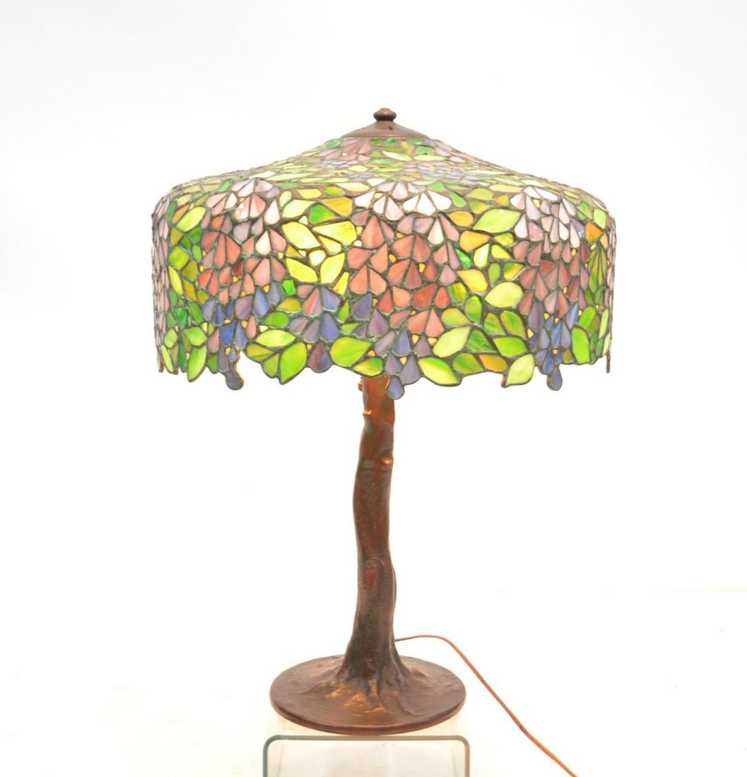 HANDEL "WISTERIA" LEADED GLASS TABLE LAMP: LARGE SIGNED HANDEL LEADED & STAINED GLASS SHADE IN WISTERIA PATTERN , ON SIGNED HANDEL TREE FORM BASE - SHADE SIGNED ON INTERIOR , BASE SIGNED ON BOTTOM , Base has 3 lights that look to be all origin