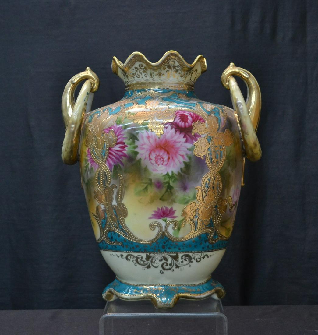 LARGE HAND PAINTED NIPPON VASE WITH: HAND PAINTED FLOWERS SURROUNDED BY GOLD DECORATIONS & TWIN RING HANDLES - 10" x 5" x 12" (UNSIGNED)