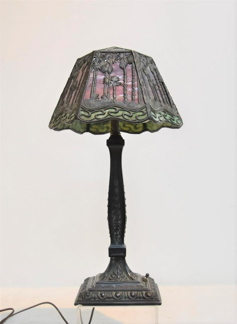 2-TONE STAINED GLASS HANDEL ? DESK LAMP: ATTRIBUTED TO HANDEL , "PALM PATTERN" 2-TONE 6-PANEL STAINED GLASS LAMP WITH FILIGREE METAL PALM TREES - 9" x 7" x 19" ; SHADE HAS HANDEL TAG ; (2 SMALL CRACKED PANELS) BASE IS UNMARKED ; SHADE HAS BE