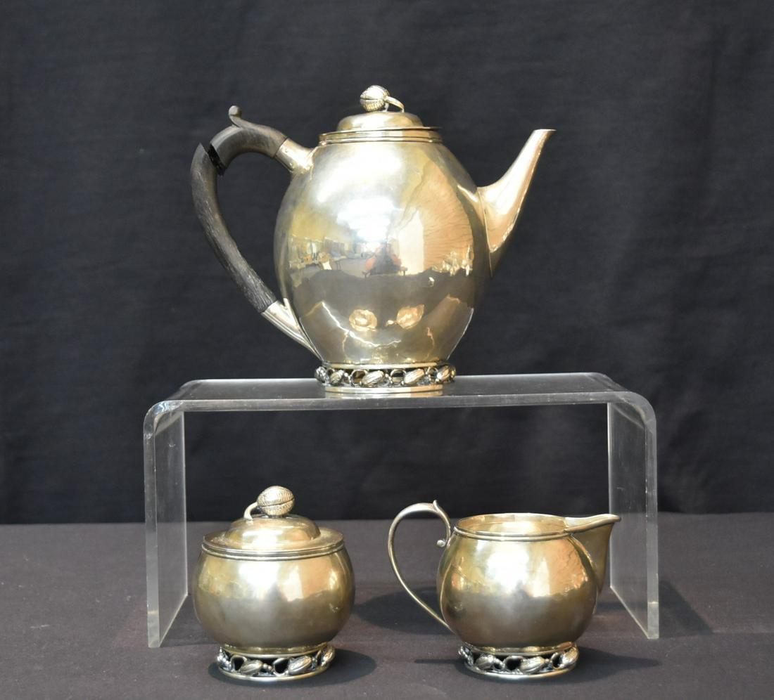 (3)pc GEORGE JENSEN STERLING SILVER TEA SET: (3) GEORGE JENSEN STERLING SILVER SET WITH WOOD HANDLES (ONE HANDLE NEEDS REPAIR) 31.5ozt ; 7 1/2" x 4" x 6 1/2"