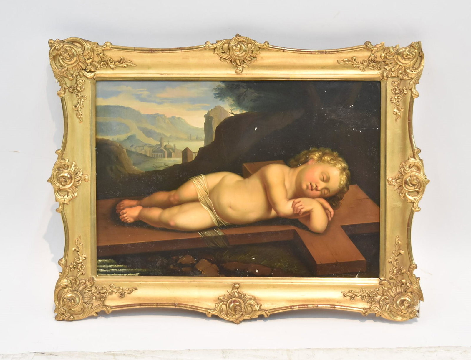 AFTER ALBANI FRANCESCO (1578-1660): OIL ON TIN PAINTING OF A RECLINING INFANT CHRIST SLEEPING ON CROSS WITH VIEW OF JERUSALEM IN BACKGROUND - ANTIQUE OIL ON TIM OF BABY JESUS LAYING ON CROSS , AFTER ALBANI FRANCESCO - TIN IS 18 3/4" x 1