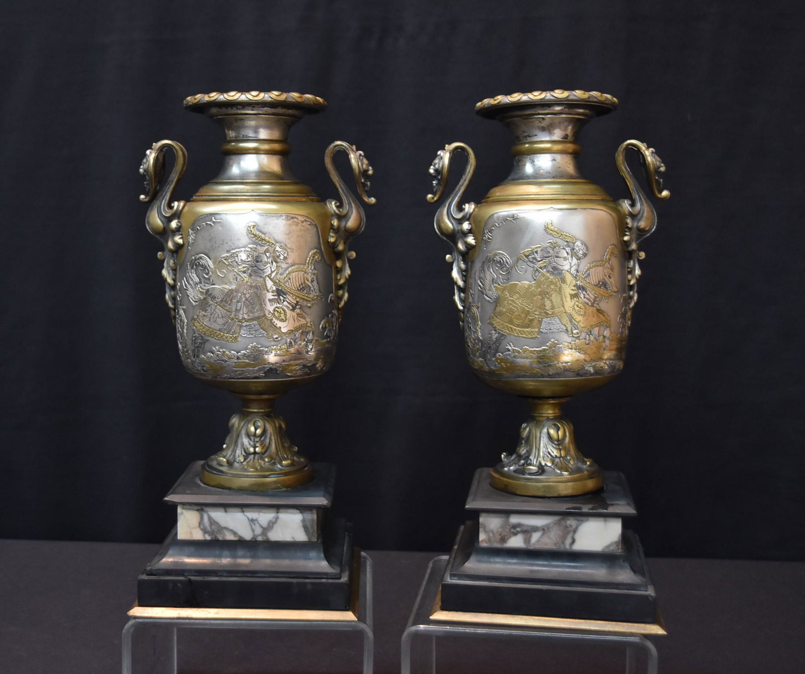 (Pr) FRENCH ? BRONZE & SILVER INLAID VASE URNS: (Pr) FRENCH BRONZE GARNITURE VASES WITH SILVER INLAID FIGURAL MEDALLIONS OF KNIGHT ON HORSEBACK & LADY WITH ANIMALS INVERSO & LION HEAD HANDLES - 6" x 5 1/2" x 12 1/2"